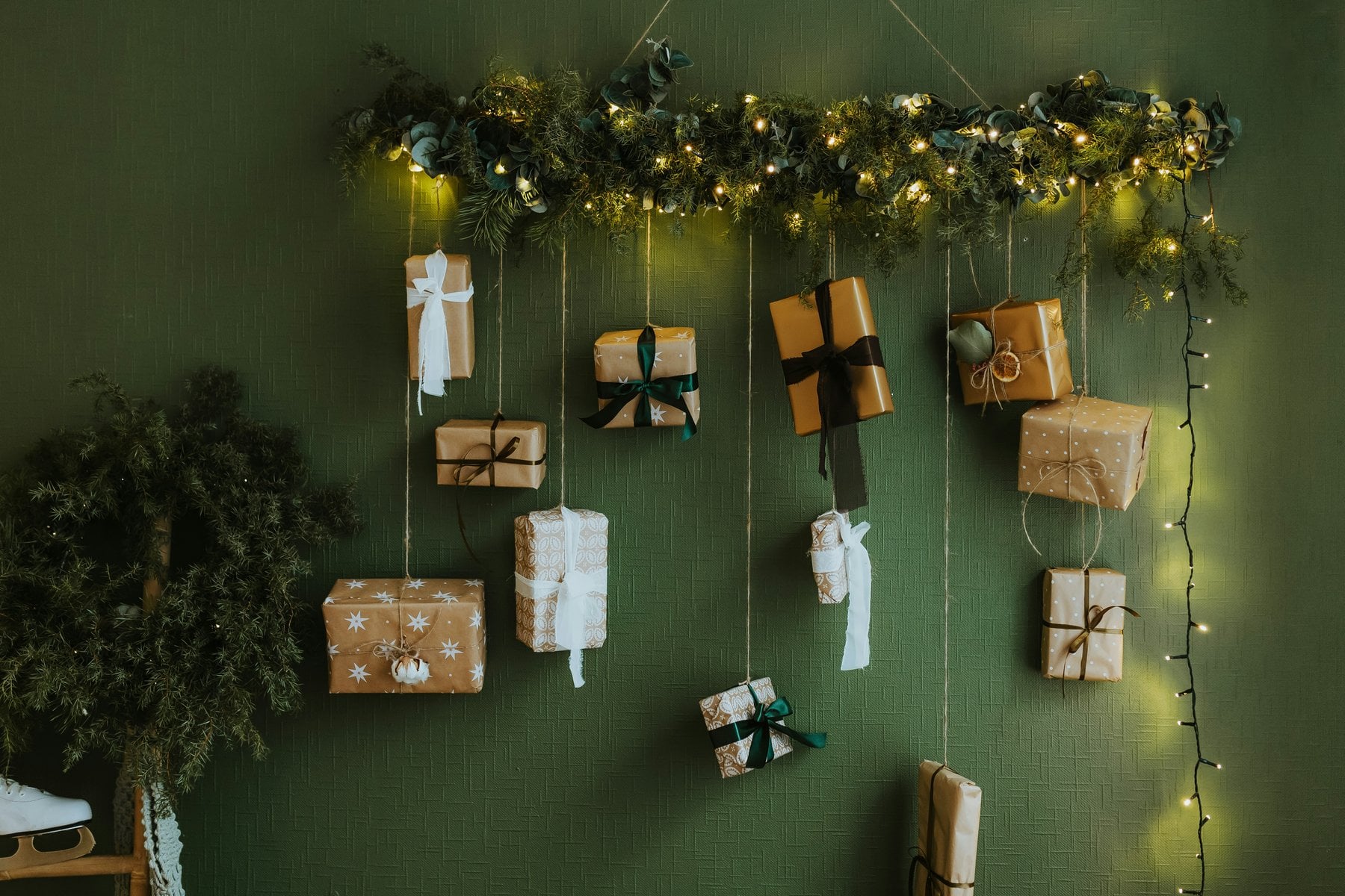 Beauty-Adventskalender 2026: selbst gemachter Adventskalender mit kleinen Päckchen an einer grünen Wand mit Lichterkette